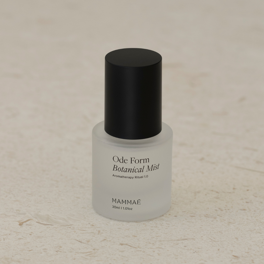 A bottle of Ode Form™ Botanical Mist by Mammae The Embodied Mother on a white surface.