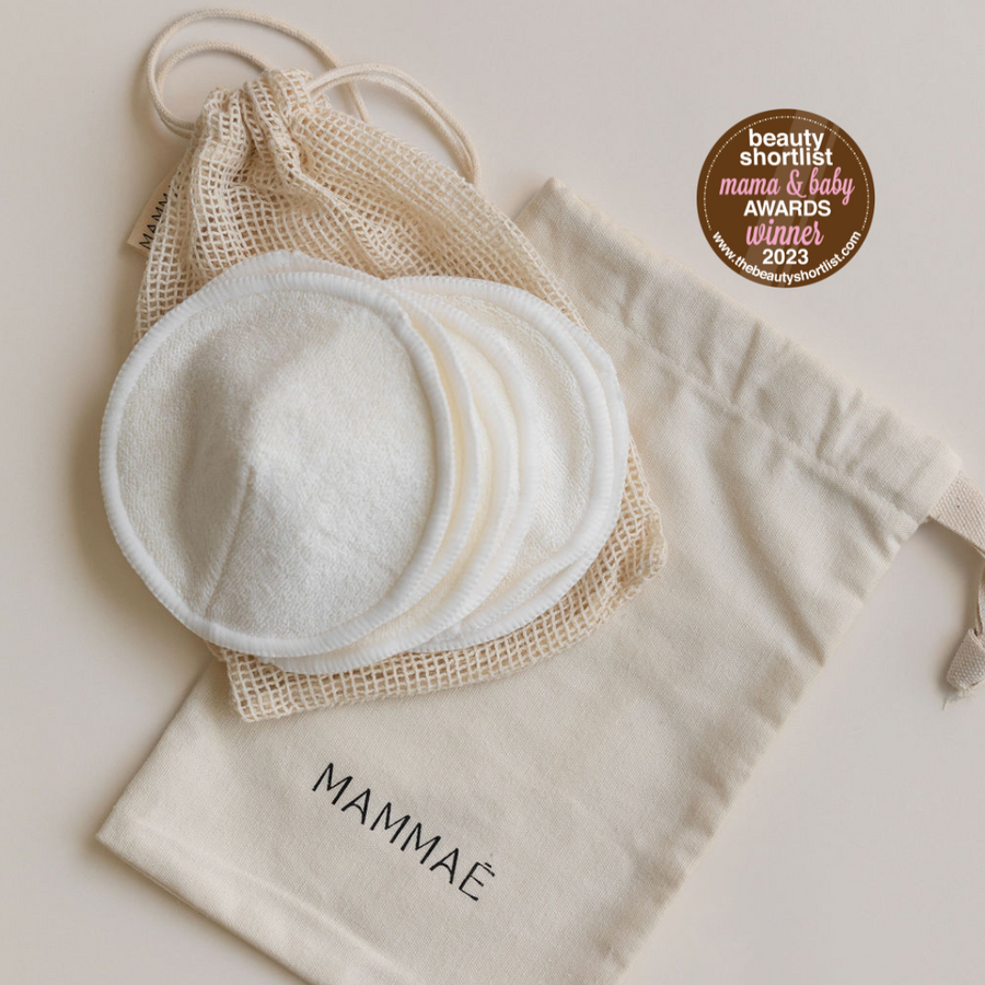 A Bosom Wearables bag with a set of Mammae The Embodied Mother organic cotton pads, designed for comfort and maximum absorbency, and a Bag with the word "mama".