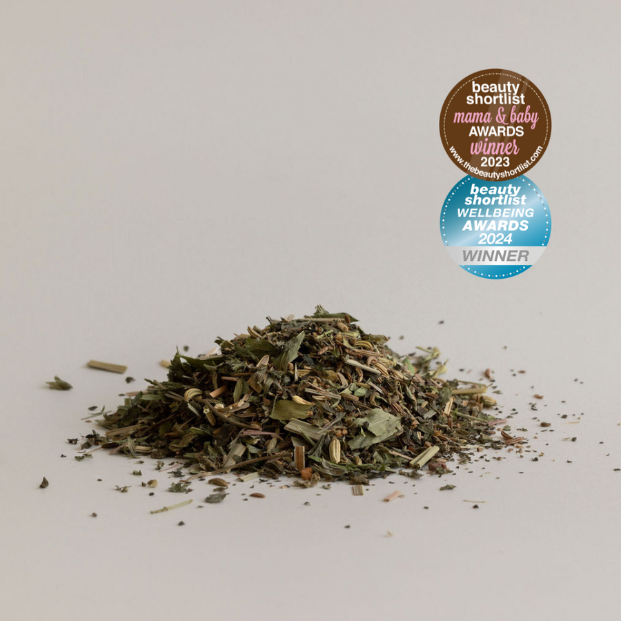 Pile of loose organic Bosom Ritual™ Infusion herbal tea leaves with award badges for beauty product recognition by Mammae The Embodied Mother.