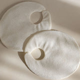 Two natural eco-friendly bamboo reusable fabric covers on a beige background with soft shadows of the Mammae hot and cold packs for breastfeeding and lactation support. 