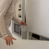 postpartum mother holding a mammae hot and cold thermal therapy breast care compress in a kitchen setting