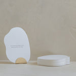 A white Bosom Reflections card with an affirmation quote on it sitting on a table, branded by Mammae The Embodied Mother.