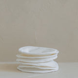 A stack of Bosom Wearables cloth diapers from the Mammae The Embodied Mother brand, stacked on top of each other.