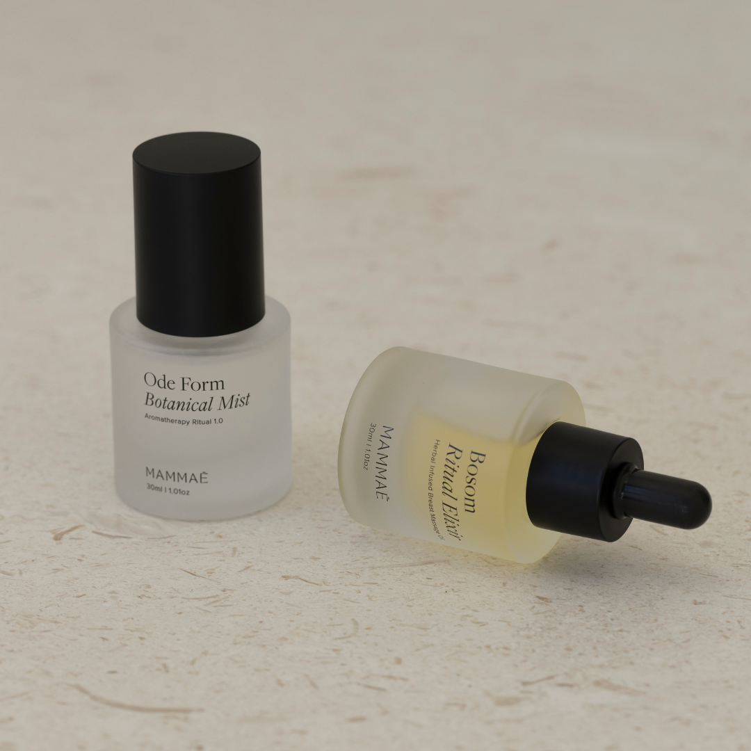 A Mini Bosom Ritual™ Elixir bottle and a Mini Bosom Ritual™ Elixir bottle next to each other, both from Mammae The Embodied Mother.