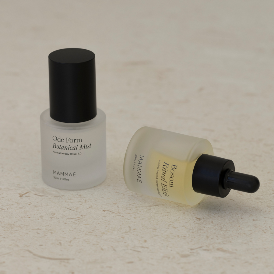 A Mini Bosom Ritual™ Elixir bottle and a Mini Bosom Ritual™ Elixir bottle next to each other, both from Mammae The Embodied Mother.